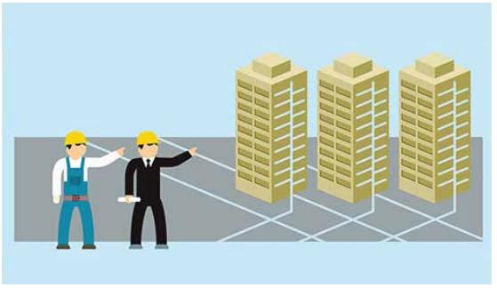 A person in a suit and helmet standing next to a couple of tall buildings

Description automatically generated